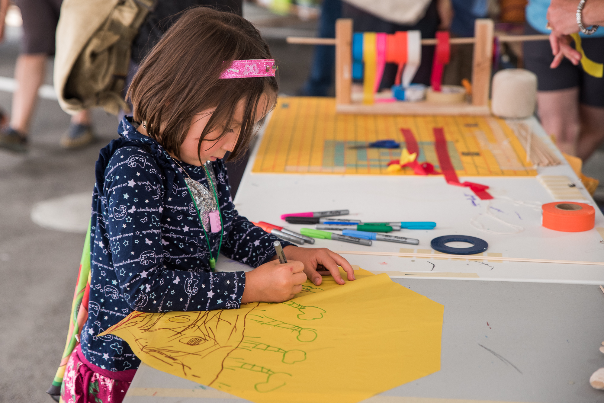 A young child creates art at MoPOP's Maker Faire
